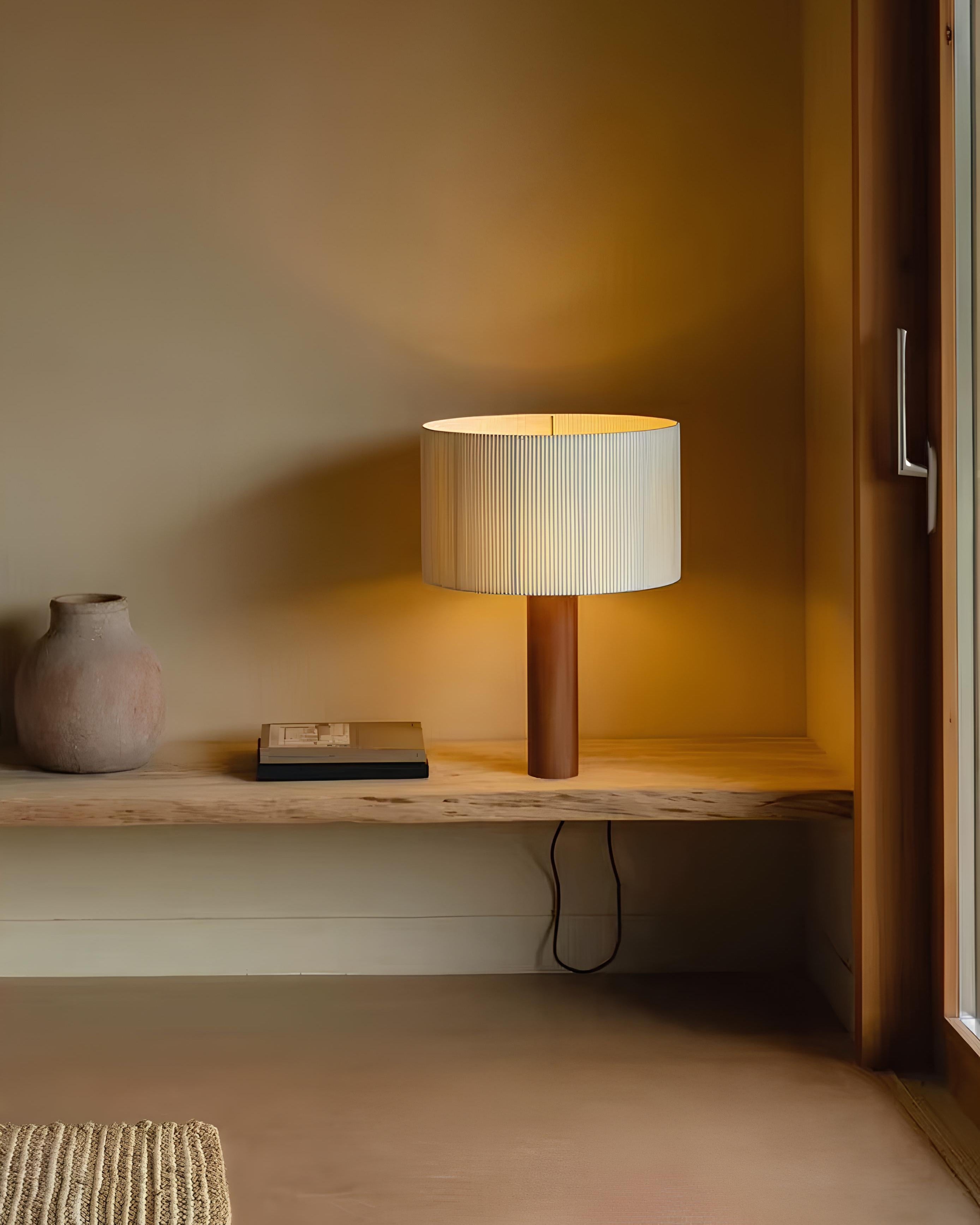 Wabi-sabi bedside table lamp casting warm light