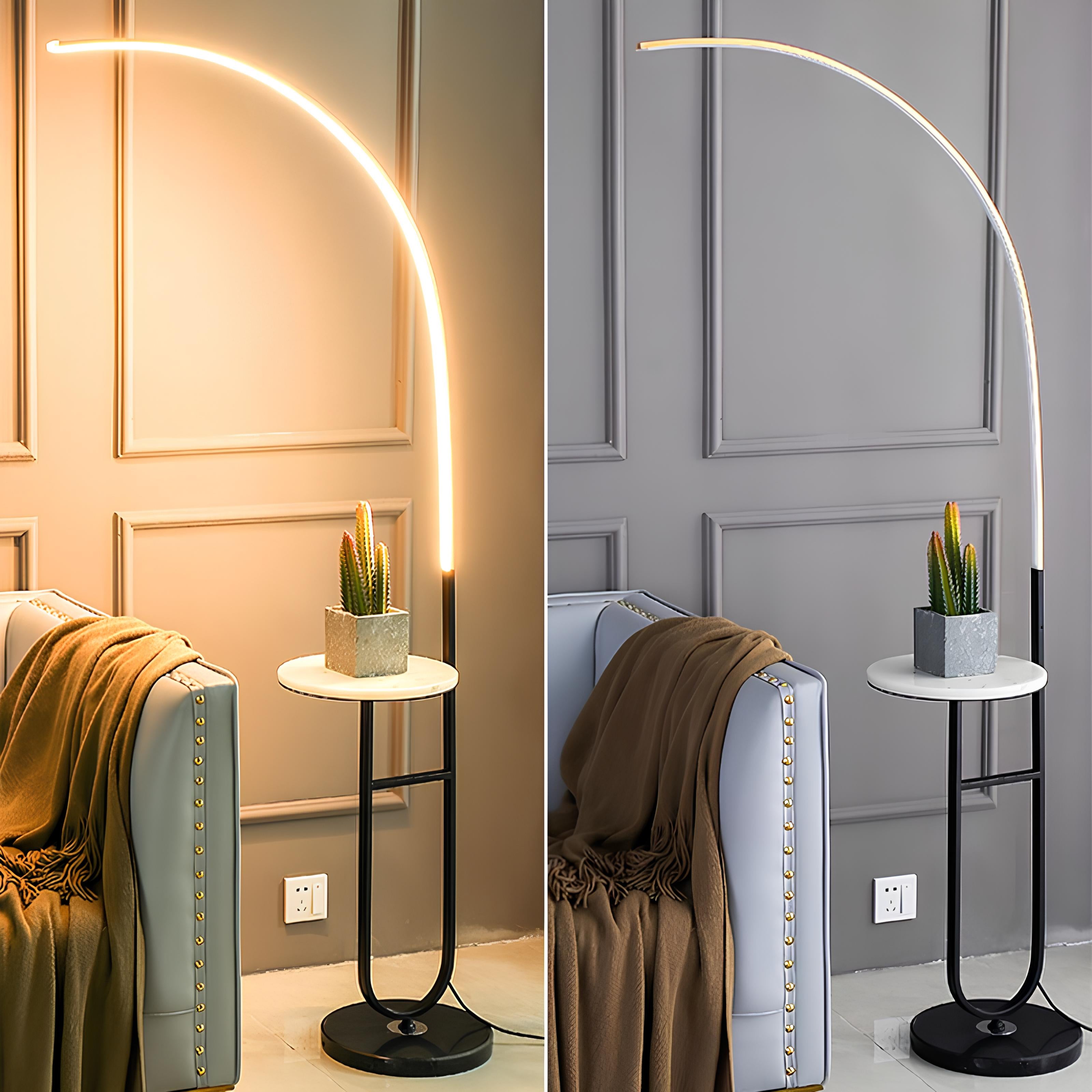 Sculptural gold lamp with side table and curved LED arm