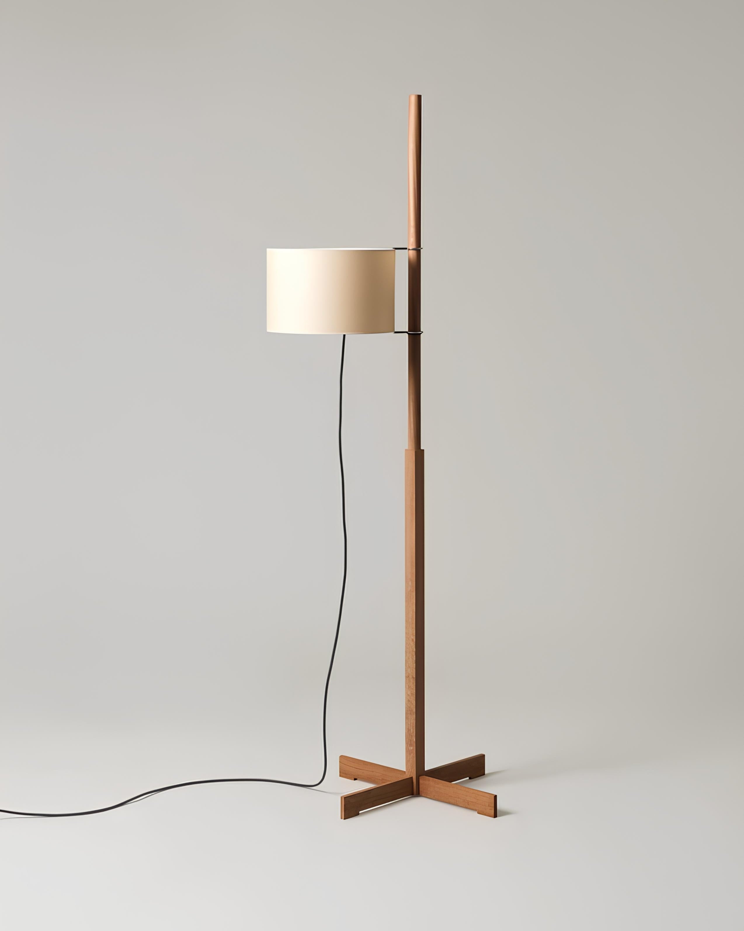 Mizu floor lamp with walnut wood frame beside reading chair