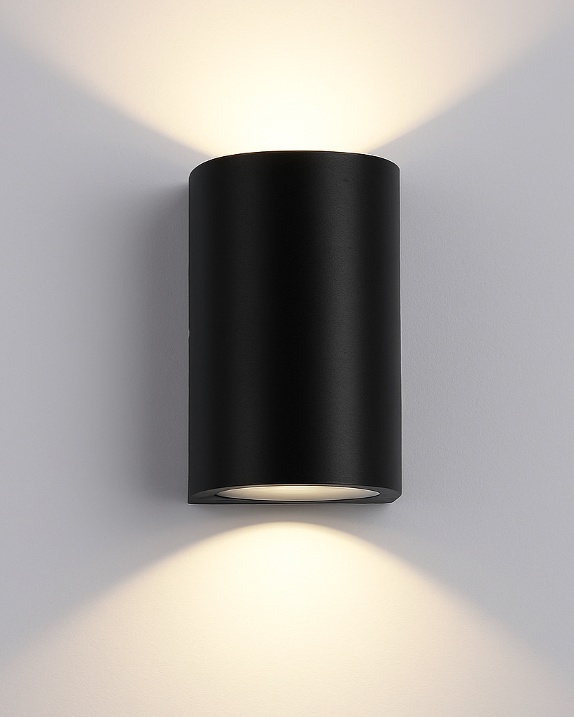 Luna wall lamp illuminating an entryway at night