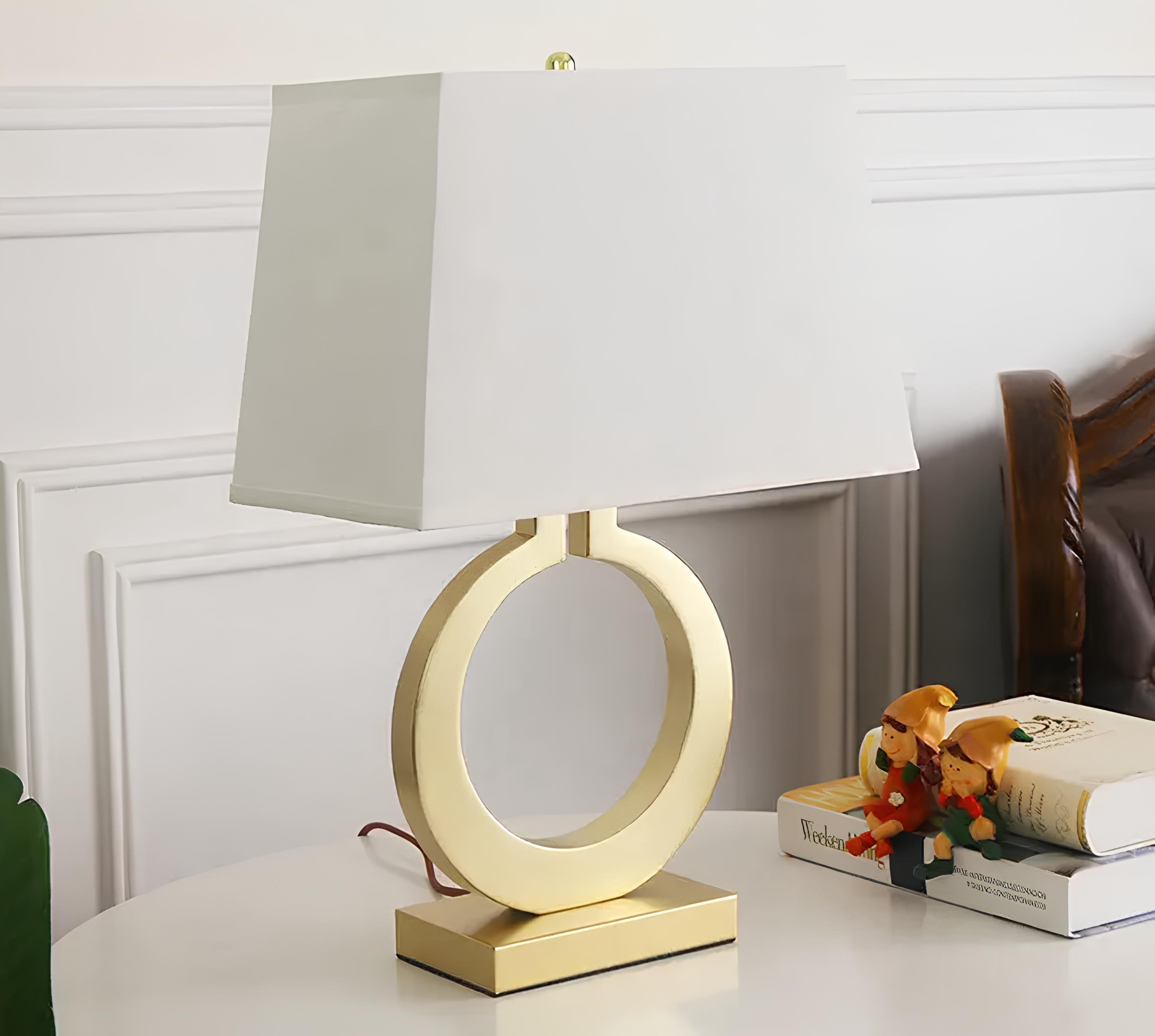 Close-up of textured fabric lamp shade with sculptural metal base