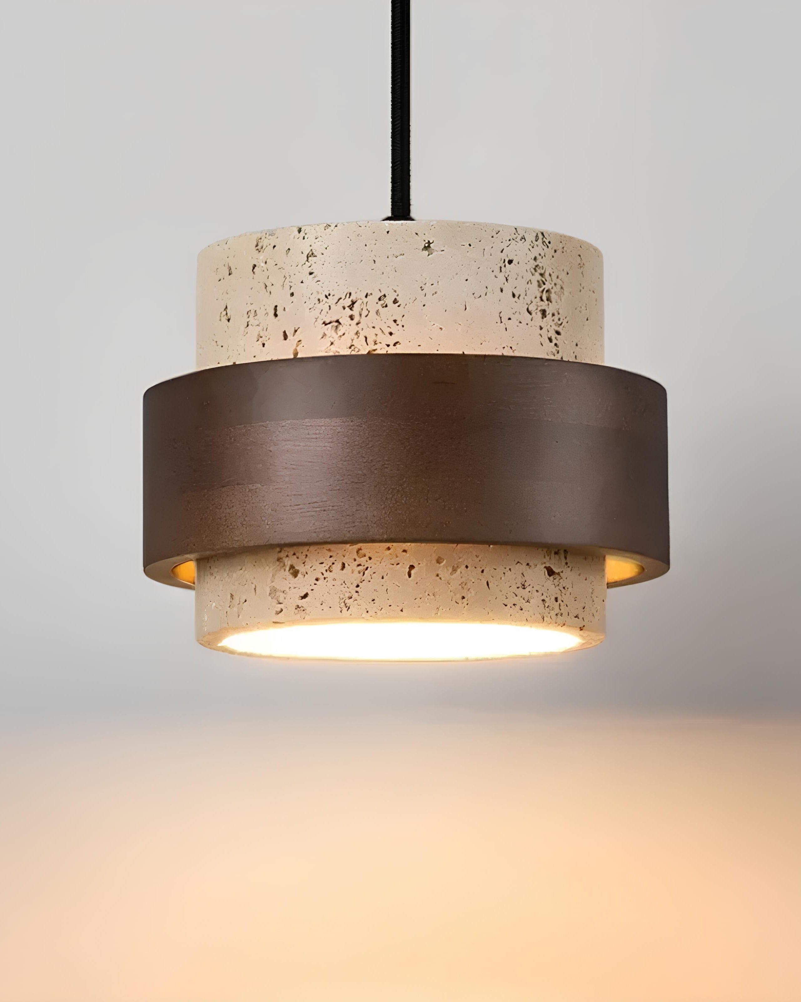 Stone and wood pendant light hanging over bedside table
